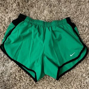 Size Small green Nike running shorts. The logo and stripe on hip are reflective.